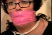 25 YEAR OLD DAY CARE WORKER IS MOUTH STUFFED, HANDGAGGED, WRAP BONDAGE TAPE GAGGED, TOE-TIED WEARING NYLON STOCKINGS WHILE TIED TO A CHAIR AND WEARING EYE GLASSES (D72-6)