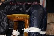 Watching sexy Sandra wearing a sexy blue shiny nylon pants and a rain jacket being tied and gagged with ropes and a clothgag on a stool (Pics)