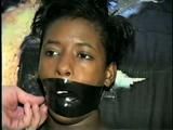 BLACK SHONDA IS WRAP TAPE GAGGED & BOUND UP WITH BLACK ELECTRICAL TAPE (D33-10)