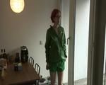 Marlin in the kitchen preparing a coffee wearing a green shiny nylon shorts and a green rain jacket (Video)