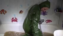 Mara ties, gagges and hoodes herself in a bath tub with muddy water wearing a sexy rainwear jumpsuit with hood (Video)