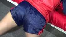 Watching sexy Sonja wearing a blue/red shiny nylon shorts and blue/red rain jacket during her workout with dumbbells (Video)
