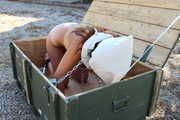 tied tightly in a box with chains