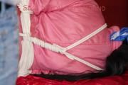 Lucy tied and gagged on a sofa wearing a pink shiny nylon skibib (Pics)