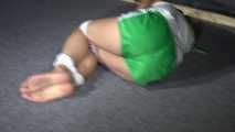 Sexy Sandra being tied and gagged on the floor wearing a sexy green shiny nylon shorts and a white top (Video)