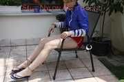 Sexy Mara being tied and gagged on a chair outdoor wearing a sexy shiny nylon shorts and a rain jacket (Pics)