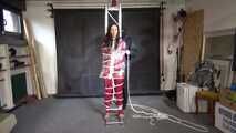 Aiyana in a shiny nylon red rainsuit and a see through PVC Rainjacket, tied gagged, hooded and vibed