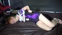 Red haired Woman bound and gagged in a shiny purple wetlook Dress