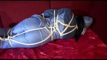 Lucy tied and gagged on the sofa wearing an oldschool blue downsuit (Video)
