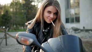 Biker girl Kate is smoking Marlboro Red 100s and posing for us