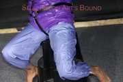 Watching sexy Sandra wearing a sexy blue rain pants and a purple down jacket being tied, gagged and hooded on a chair (Pics)