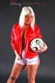 Sexy blonde-haired archive girl posing in a studio wearing a white shiny nylon shorts and a red rain jacket (Pics)