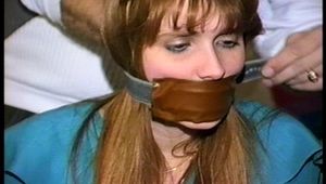 19 YR OLD NURSE'S AID  GETS BANDANNA GAGGED, HOME MADE LEATHER STRAP GAGGED, BALL-GAGGED AND TIED TO A CHAIR WITH ROPE (d-71-09)