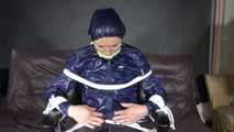 Sexy Ronja being tied, gagged and hooded on a chair with a clothgag wearing sexy blue shiny nylon rainwear (Video)
