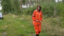 Miss Petra takes a walk in a orange AGU rain suit and rubber boots