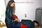 Jill tied and gagged by Petra bending over an commode bopth wearing sexy shiny nylon rainwear (Pics)