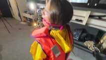 Marie M in a customer wish video handcuffed in Rainwear and a lifevest.