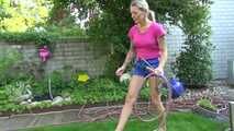 Watch Maly in her shiny nylon Shorts enjoying the warm Weather in the Garden