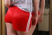 *** Watching sexy archive girl wearing a sexy red shiny nylon shorts and a white tshirt posing for you infront of a mirror (pics)***
