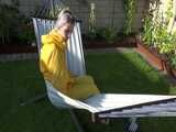 Watch Chloe enjoying the warm Sun in her yellow shiny nylon Rainsuit 