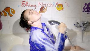 Have a look on Jill wearing a sexy shiny nylon shorts and a rain jacket while taking a foam bath (Pics)