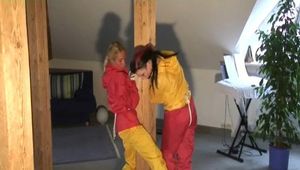 a video with two of our archive girls bound and gagged in shiny nylon rainsuits