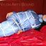 Lucy tied and gagged with a rope and a gag on a red sofa wearing an oldschool blue downwear combination (Pics)
