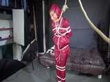 Watch Sandra bound gagged and noosed wearing her shiny nylon Rainwear