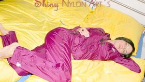 ENNI wearing a sexy purple shiny nylon rain suit lying in bed with yellow shiny nylon cloths lolling and posing (Pics)