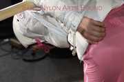 Watching sexy Sandra wearing a sexy pink shiny nylon rainpants and a special white down jacket being tied and gagged and hooded with ropes and a ballgag on a bar (Pics)