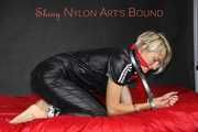 Sexy Sonja being tied and gagged with cuffs, a pillory and a clothgag wearing a supersexy black shiny nylon rainsuit (Pics)