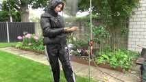 Watching Aiyana wearing a sexy black shiny nylon rainpant and a black shiny nylon down jacket trying the garden shower  (Video)