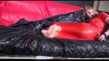 Pia wearing an supersexy red rain catsuit tied and gagged with neck ties on a sofa (Video)