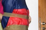 Simone tied and gagged in shiny nylon rainwear