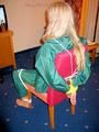 Blonde archive girl tied and gagged in an green shiny nylon rainsuit on a chair (Pics)