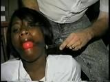 26 YR OLD BLACK BANK TELLER IS MOUTH STUFFED, HANDGAGGED, CLEAVE GAGGED, BALL-GAGGED, BAREFOOT & BALL-TIED ON THE FLOOR (D55-7)