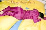 ENNI wearing a sexy purple shiny nylon rain suit lying in bed with yellow shiny nylon cloths lolling and posing (Pics)