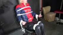 Watzching sexy PIA wearing a sexy oldschool rainwear combination in red/blue sitting on a hairdresser´s chair being tied and gagged from Sophie (Video)