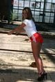 Stella posing outdoor wearing a supersexy red shiny nylon shorts and a white top (Pics)