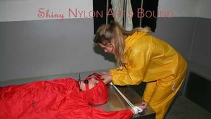 Watching Stella being tied and gagged with ropes and a ballgag on a operating table from Leonie both wearing sexy shiny nylon rainwear (Pics)