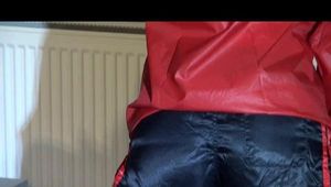 Sonja wearing a darkblue shiny nylon shorts size 3 and a red shiny nylon rain jacket during her workout on the crosstrainer (Video)