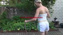 Sexy Sonja wearing a *white* shiny nylon shorts with a white top durig watering the garden (Video)