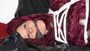 Lucy tied, gagged and hooded on a sofa wearing a sexy darkred downwear combination (Pics)