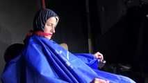 Watching Sonja sitting on a hairdresser`s chair wearing sexy blue shiny nylon rainwear with a raincape being tied, gagged and hooded with ropes and a clothgag (Video)