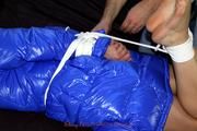 Simone tied and gagged in a shiny nylon downcoat