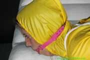 Get Pictures of Pia bound and gagged in her yellow shiny nylon Rainwear