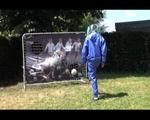Mara wearing a blue rainwear combination while playing soccer with herself (Video)