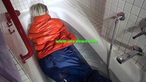 Sexy Sonja taking a bath in the bath tub wearing a sexy shiny nylon down jacket and a rain pants (Video)