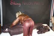 Watching ***SONJA*** wearing a sexy brown shiny nylon rainwear combination preparing her bed an lolling in the bed (Pics)