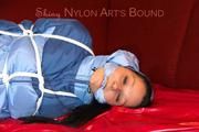 Lucy tied and gagged with a rope and a gag on a red sofa wearing an oldschool blue downwear combination (Pics)